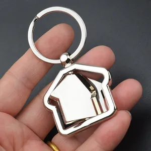 Llavero giratorio de metal plateado en forma de casa para regalos inmobiliarios