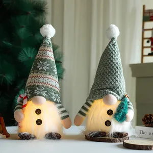 Close-up of glowing Christmas gnomes with warm lighting in a cozy holiday setting.