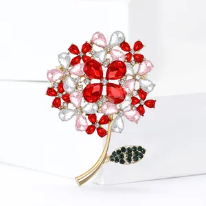 Macro detail of a luxury crystal hydrangea flower brooch with red and pink petals.