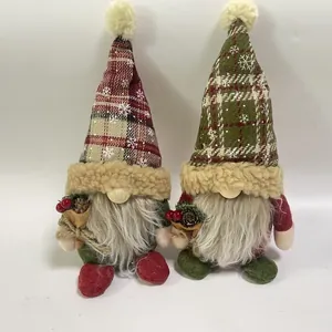 Detail view of Nordic plaid Christmas gnome dolls with white beards and festive pinecones