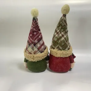 Detail view of two Scandinavian Christmas gnomes with red and green plaid snowflake hats