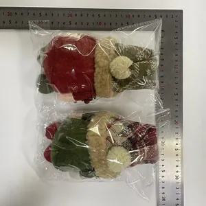 Detail view of Christmas gnome plush dolls with ruler showing size scale