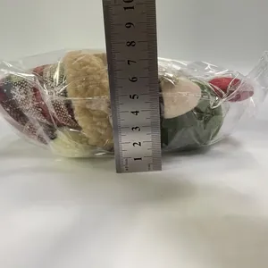 Size measurement of a retro plaid Christmas gnome plush doll in clear plastic packaging