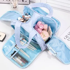Large capacity light blue travel makeup bag with multiple compartments and brush slots