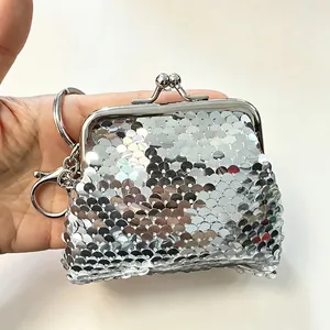 Macro view of a silver sequined mini coin purse with a secure metal kiss-lock clasp