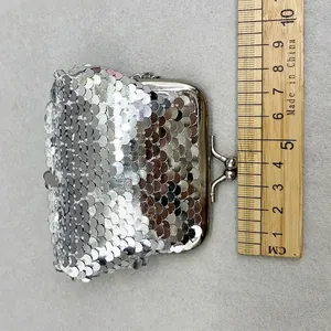 Silver sequin coin purse shown next to a ruler to indicate its small mini size.