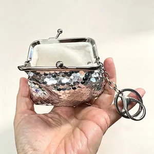 Detailed view of cute silver sequined mini coin purse with metal clasp and keychain