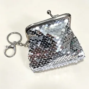 Close-up of the iridescent silver sequins and silver clasp on a mini coin purse keychain