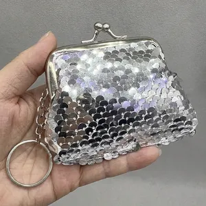 Close-up detail of a silver sequin mini coin pouch featuring a classic metal clasp