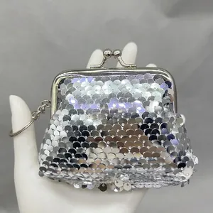 Detailed close-up of mini silver sequined coin purse with metal kiss-lock and keychain