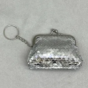 Close-up of a silver sequin mini coin purse with a metal kiss-lock and keychain.