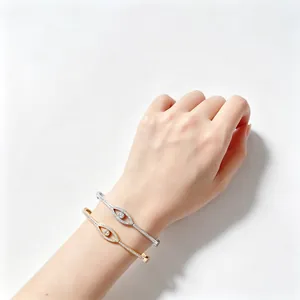 Pair of minimalist stainless steel evil eye bangles with sparkling crystals on wrist
