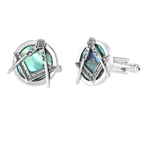 Close-up of Masonic abalone shell cufflinks with silver compass and square design
