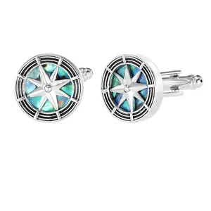 Detailed close-up of vintage silver compass cufflinks featuring natural abalone shell inlay