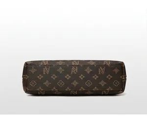 Detailed bottom view of a luxury brown monogram patterned crossbody phone bag for women