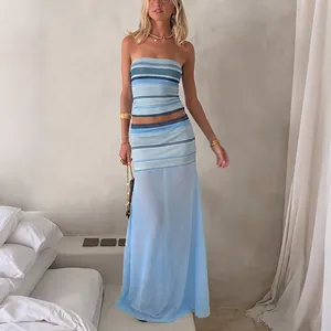 Full-body lifestyle view of a blue striped tube top and sheer mesh maxi skirt set