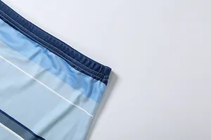 Close-up detail of striped blue mesh fabric with elastic waistband and fine stitching
