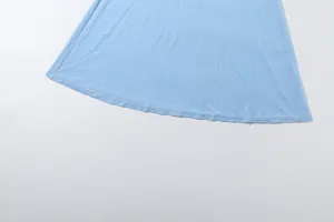 Macro view showing the fine stitching and hem of a light blue mesh skirt detail
