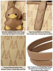 Detail view of stylish monogram tote bag featuring cartoon duck charm and precise stitching