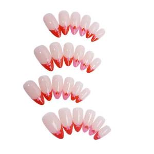 French tip press-on nails with red heart details in almond shape for manicure.