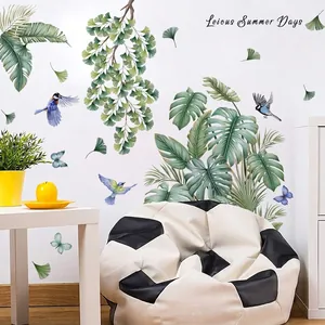 Close-up detail of nature wall stickers with monstera and ginkgo leaves in living room