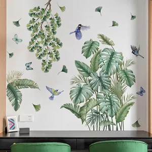 Detail view of tropical leaf, bird, and butterfly wall decals in a modern living space.