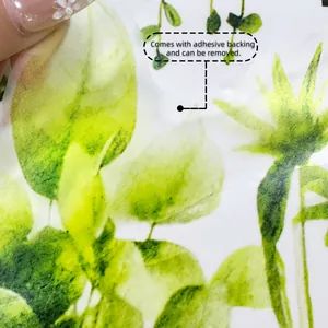 Detail showing the adhesive backing and removable nature of the green leaf wall decal