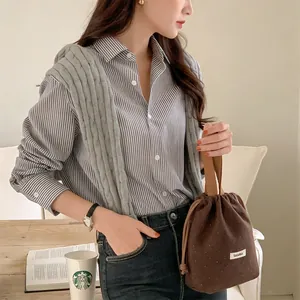 Detailed macro view of a brown woolen drawstring bucket bag with white polka dots pattern