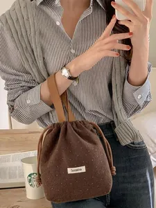 Brown wool drawstring bucket bag with white polka dots for casual shopping and daily use