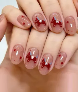 Close-up of short oval press-on nails with red horse and nude pink gradient