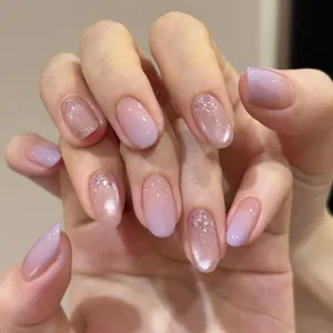 Close-up of short oval press-on nails featuring a soft lavender gradient and glitter