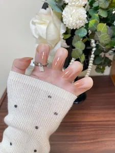Detail shot of short oval press-on nails featuring an elegant nude pink gradient finish