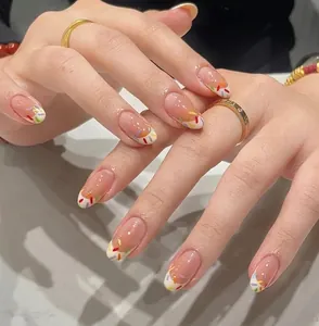 Detailed macro of oval gradient nude pink press-on nails with colorful sprinkle art