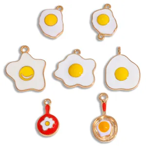 Detailed macro shot of assorted cartoon fried egg and frying pan enamel alloy DIY charms