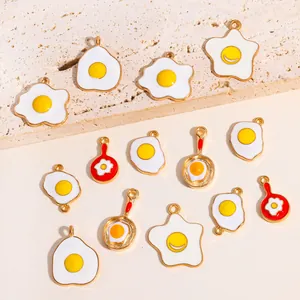 Collection of cartoon fried egg and frying pan enamel alloy charms for DIY necklaces.