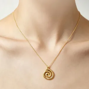 Close-up view of a gold vortex spiral pendant necklace for women on a model's neck
