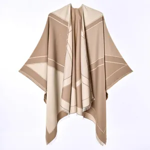 Elegant camel and beige reversible cashmere-like poncho shawl showing soft fabric texture