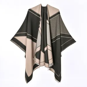 Detailed close-up view of women's color block cashmere-like poncho with elegant fringed edges