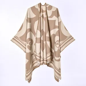 Detail view of the beige and brown camellia floral pattern on soft knit winter poncho