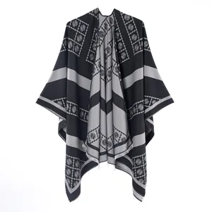 Black and grey imitation cashmere poncho with paisley patterns and fringe detail