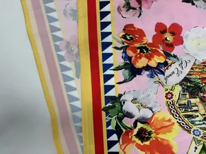 Macro detail of vibrant floral prints and geometric patterns on pink summer fashion fabric