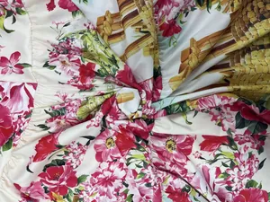 Close-up detail of vibrant floral and garden print on smooth summer fabric