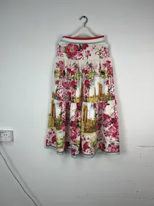 Detail of high-waisted tiered maxi skirt featuring floral and ruins print patterns.