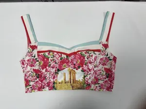 Close-up detail of a vibrant floral and ancient Greek temple print on a summer bustier top