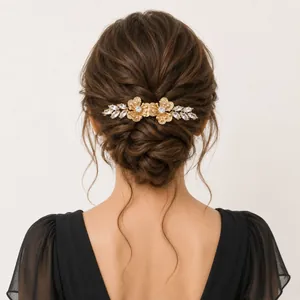 Elegant gold floral hair comb with rhinestones styled in a bridal wedding updo hairstyle