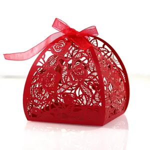 Elegant red laser-cut wedding favor box with intricate rose patterns and ribbon
