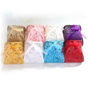 Elegant assorted laser-cut floral wedding favor boxes with satin ribbons for chocolates