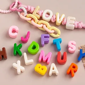 Detailed macro view of colorful large-hole acrylic alphabet beads for DIY jewelry