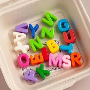Macro detail view of colorful acrylic alphabet beads with large holes for DIY jewelry crafts