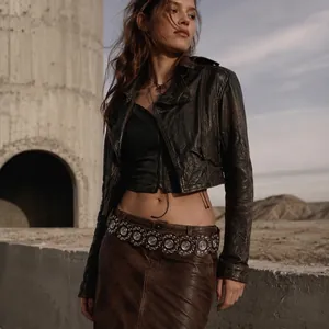 Bohemian style brown leather belt with silver metal disc ornaments shown on model